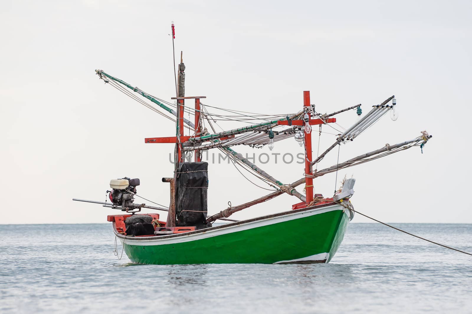 Green fishing boat thai on the sea in daylight time