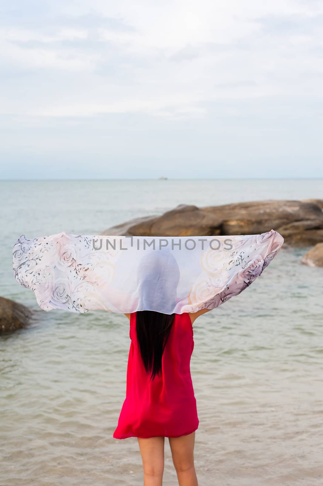 Girl holding Scarf at wind on the beach by moggara12