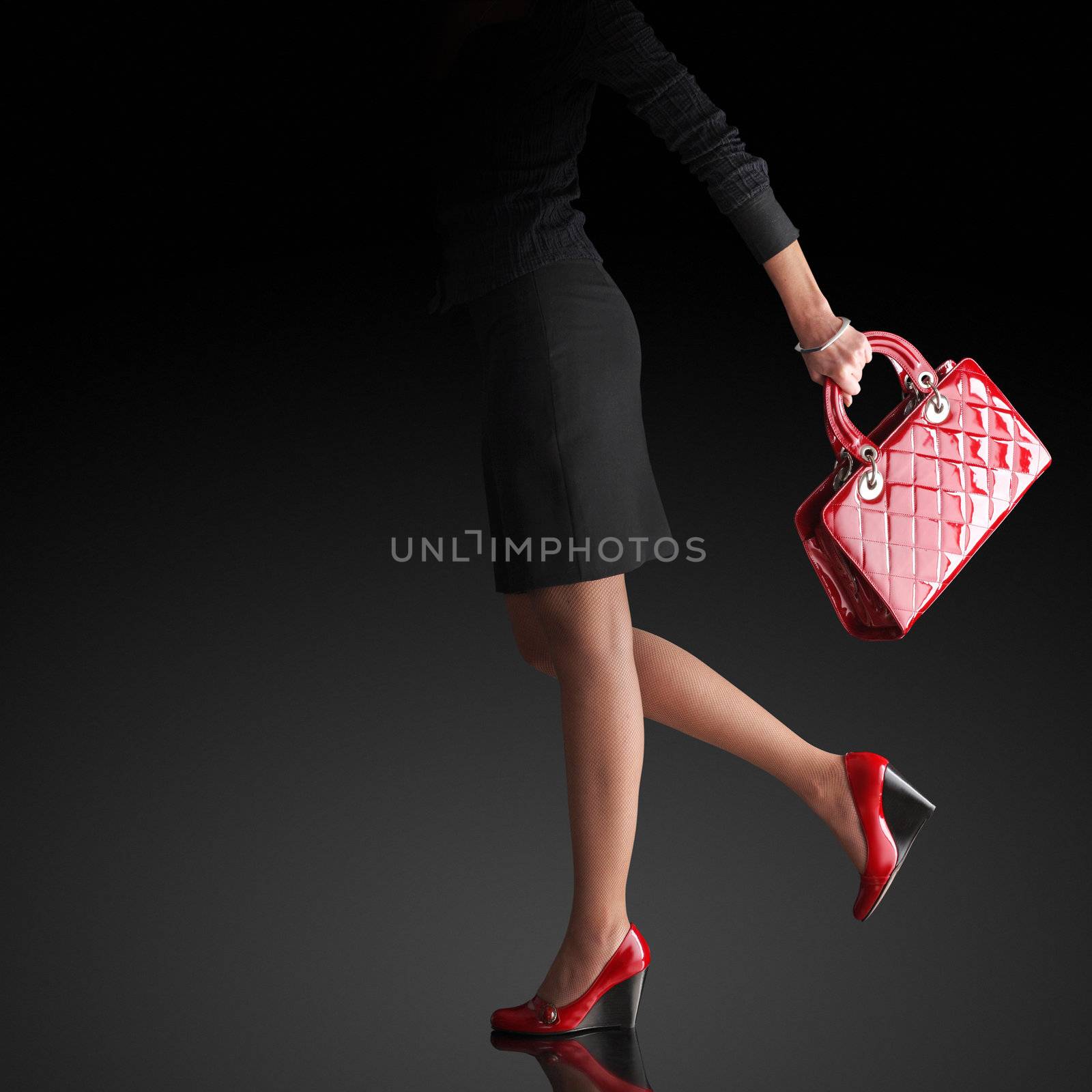 Woman sexy legs with handbag. Shopping and business  by stokkete