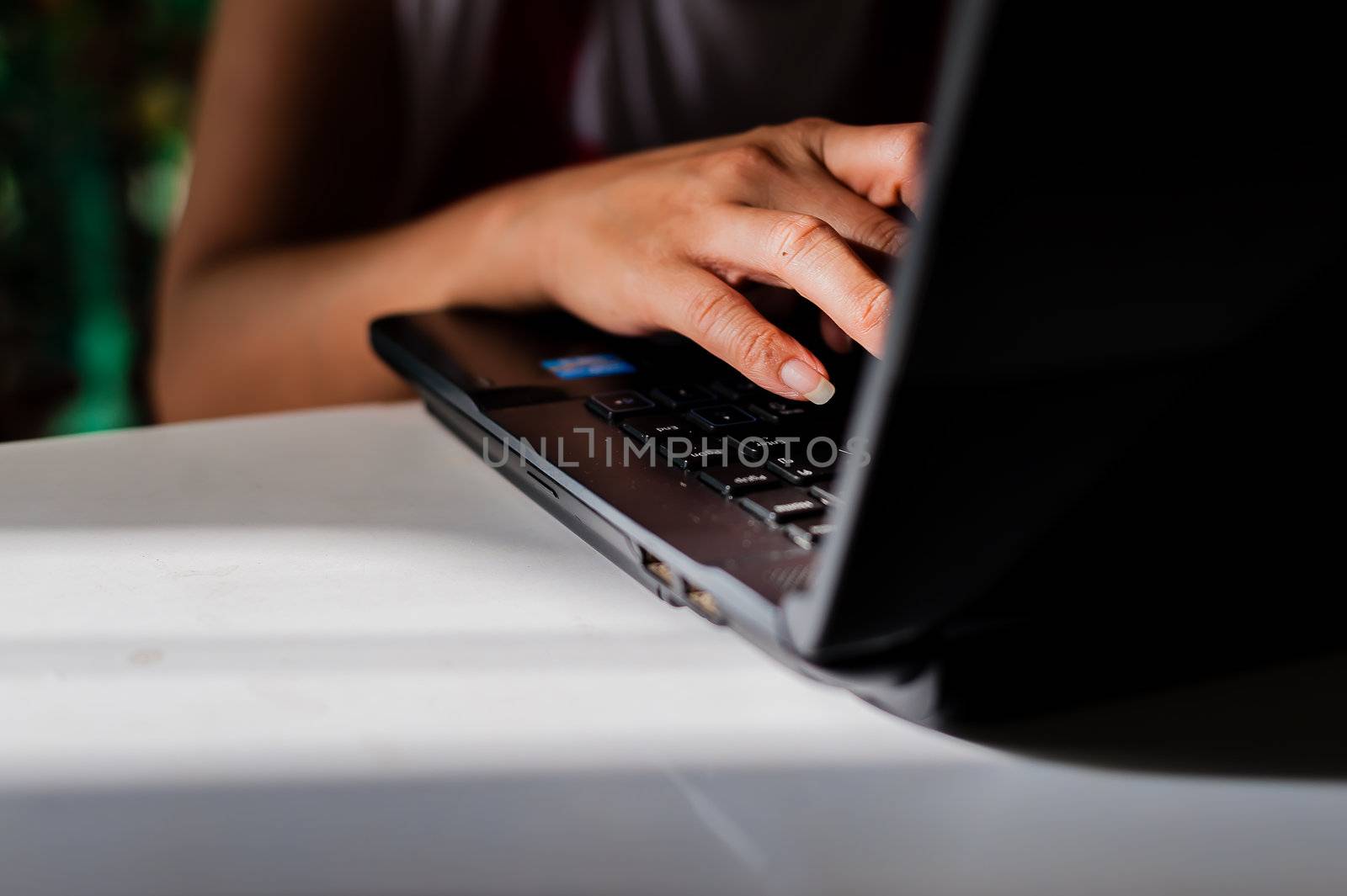 Women hands on a computer keyboard with naturelight