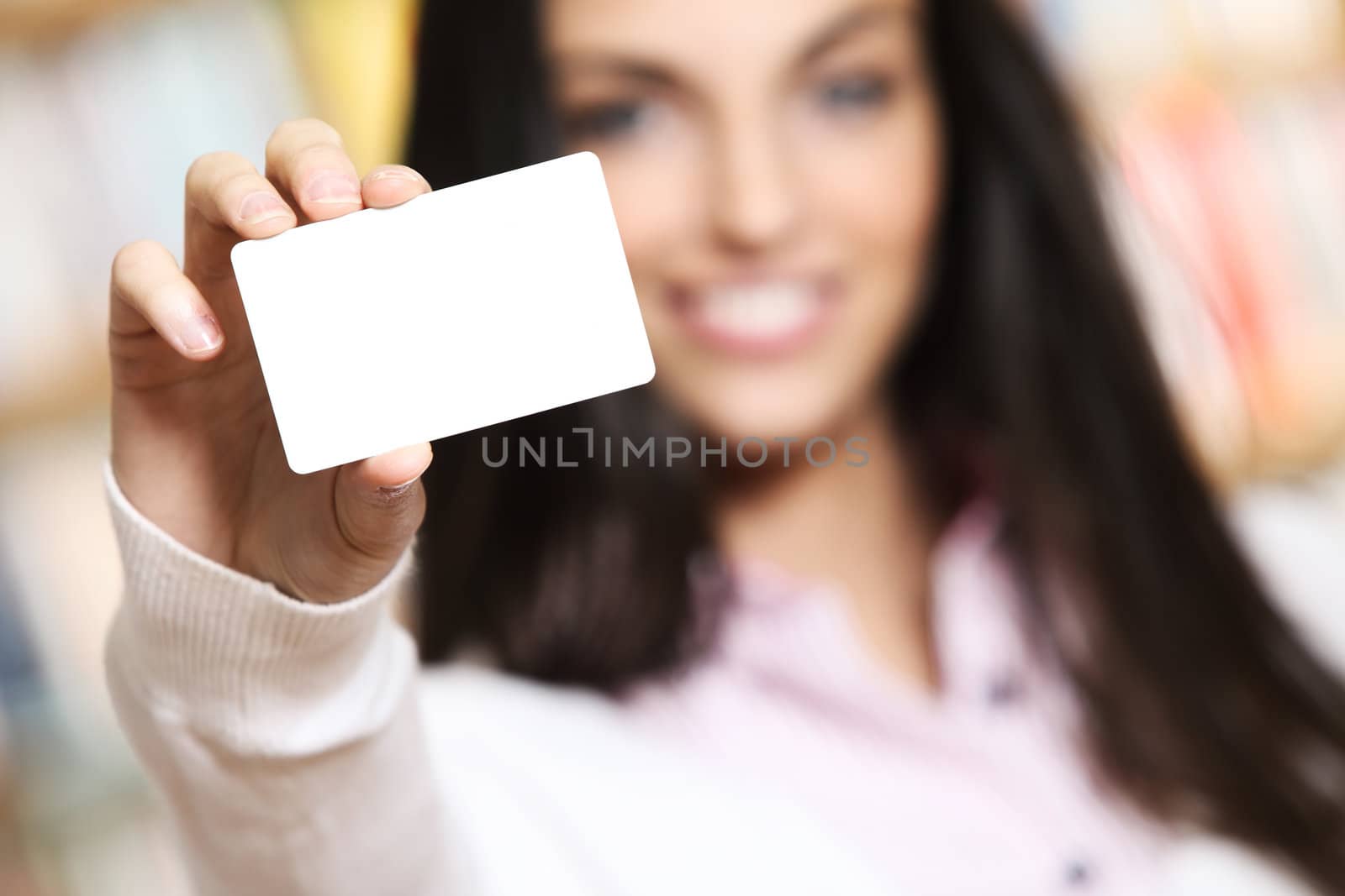 smiling young female showing a business card  -  copy space.