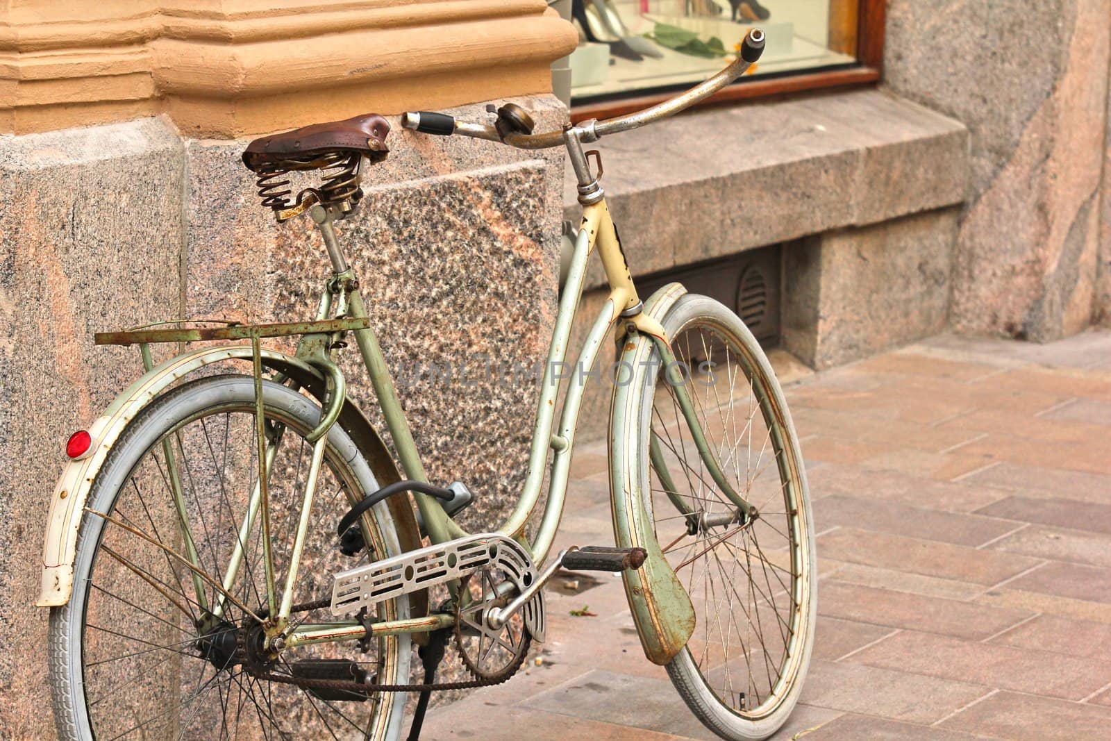 Old bike left next to a old building in city center