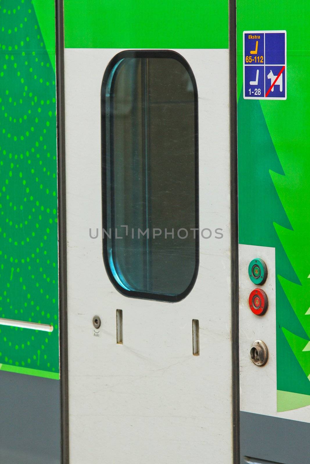 Closeup of stationary train with closed cars doors by Arvebettum
