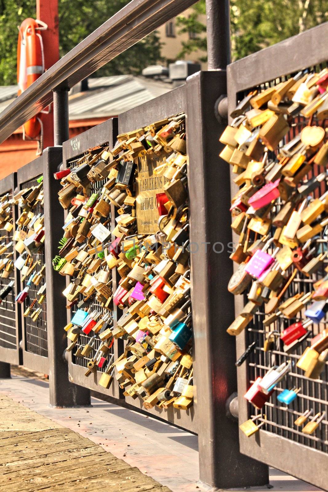 Bridge of love, locks locked onto a bridge by Arvebettum