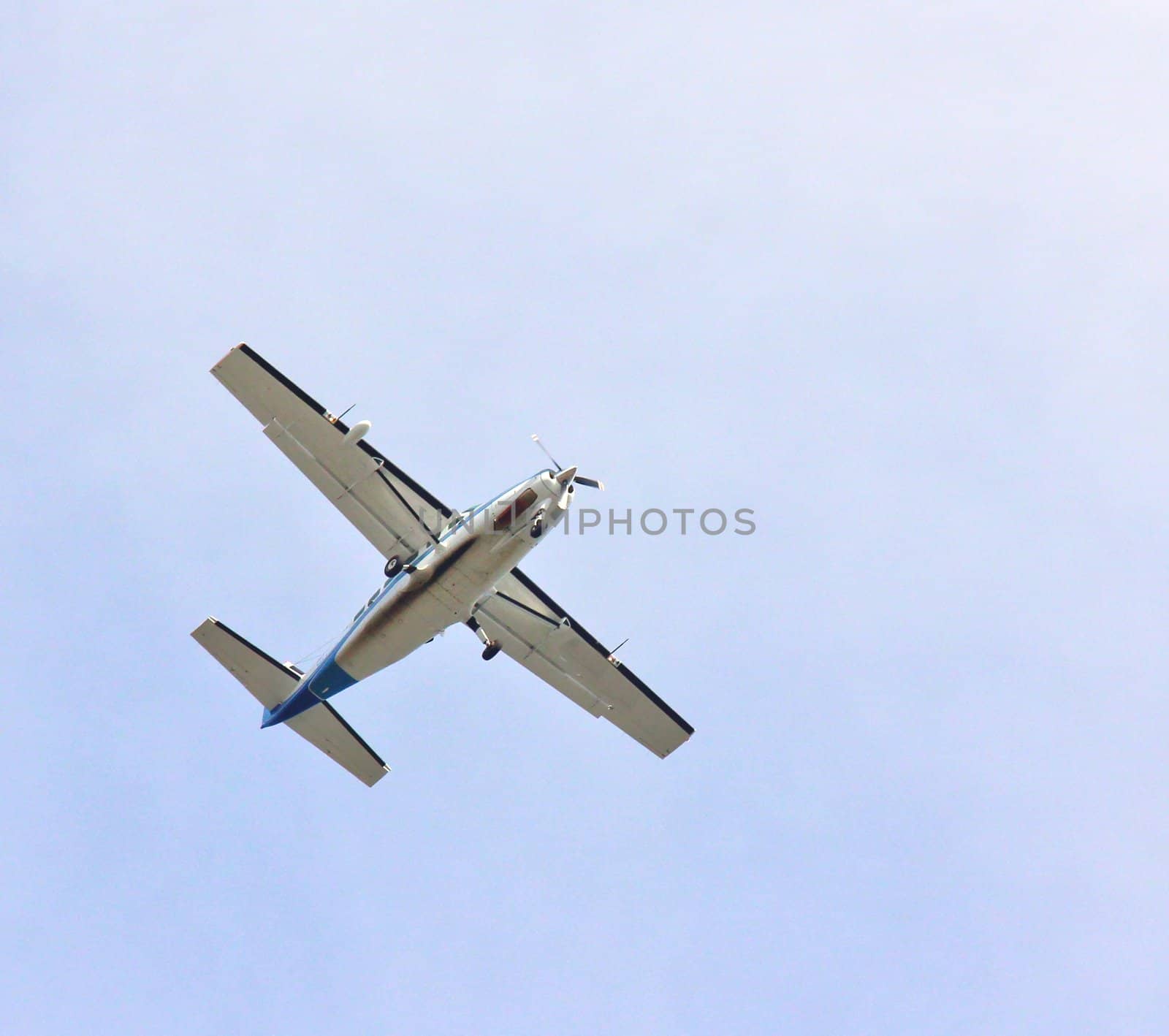 Small propel plane towards blue sky, isolated by Arvebettum