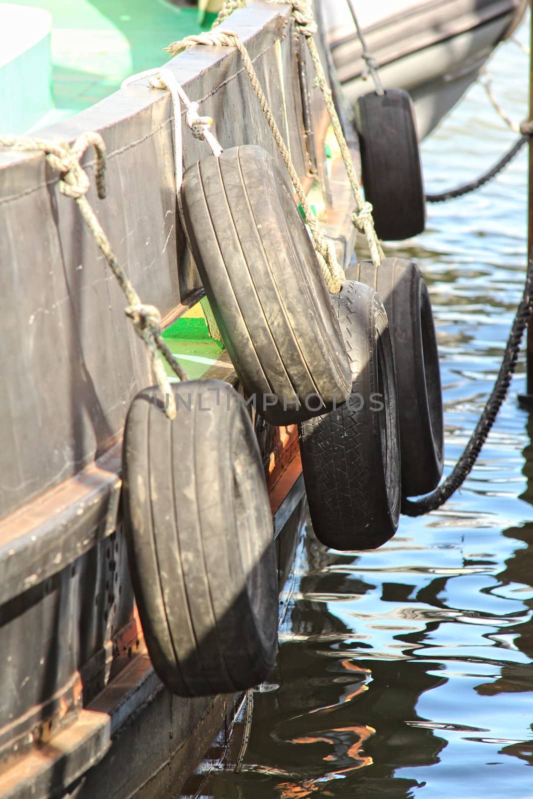 Car tire tied for protect bumping on boat