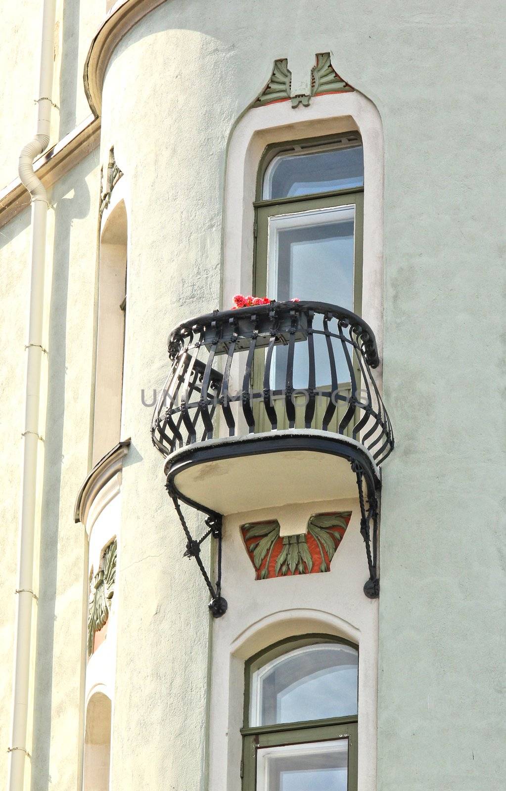 Balcnoy with flowers with a steel fenc on a concrete building