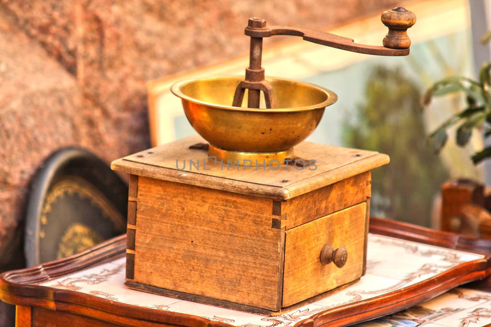 Old wooden coffee grinder, for sale outdoors by Arvebettum