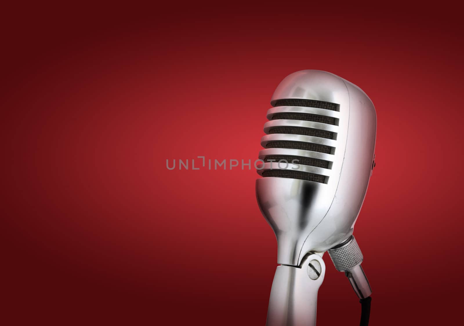 Retro style microphone.Red background by stokkete