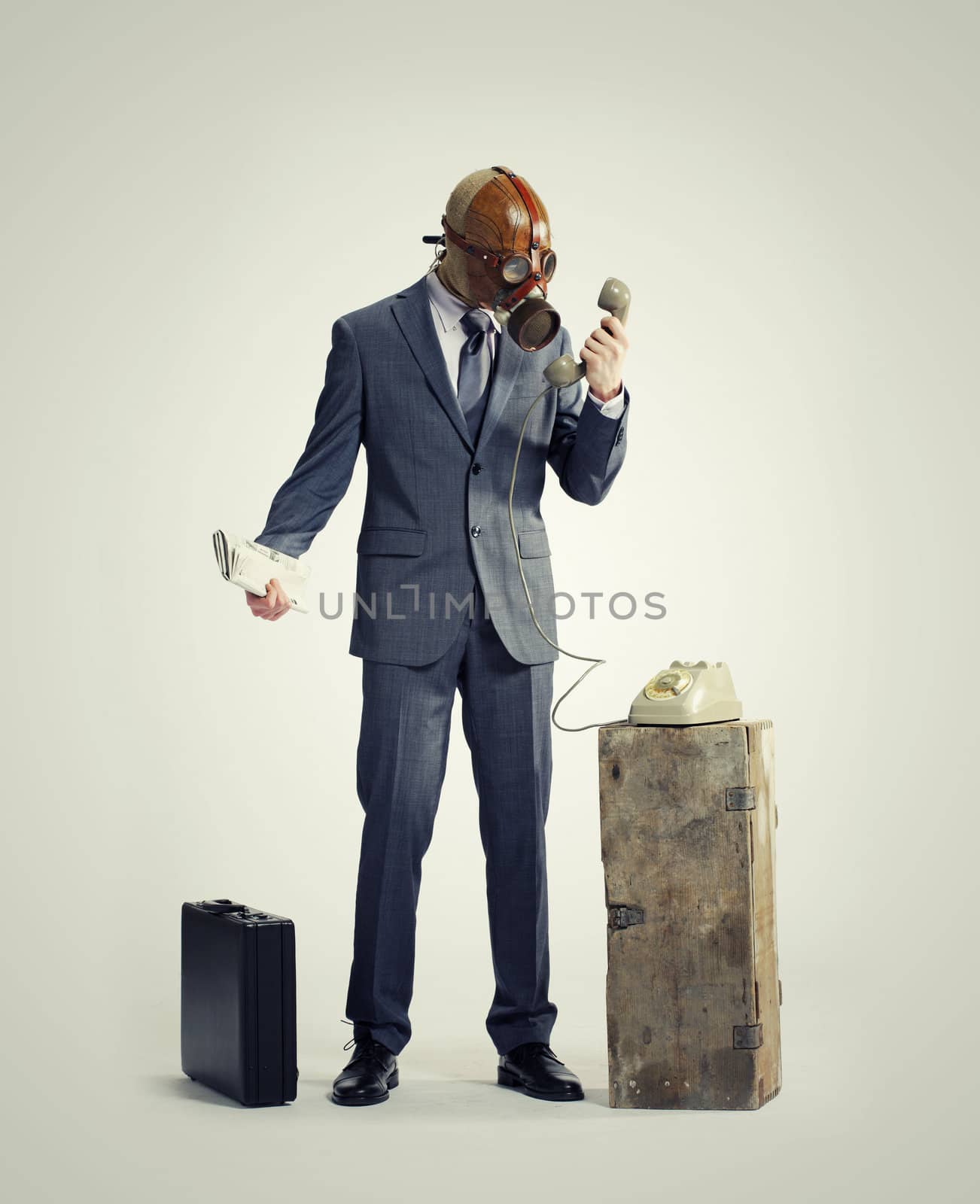 businessman with gasmask at phone by stokkete