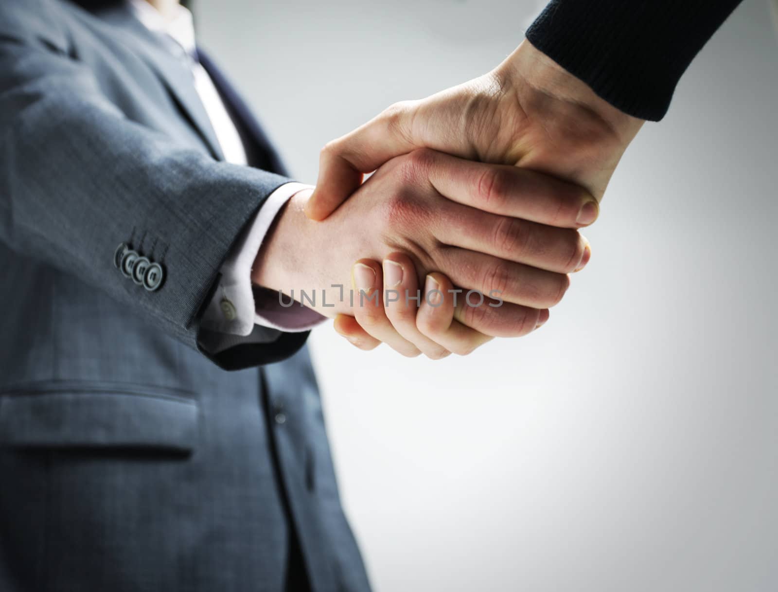 Two businessmen shaking hands. by stokkete