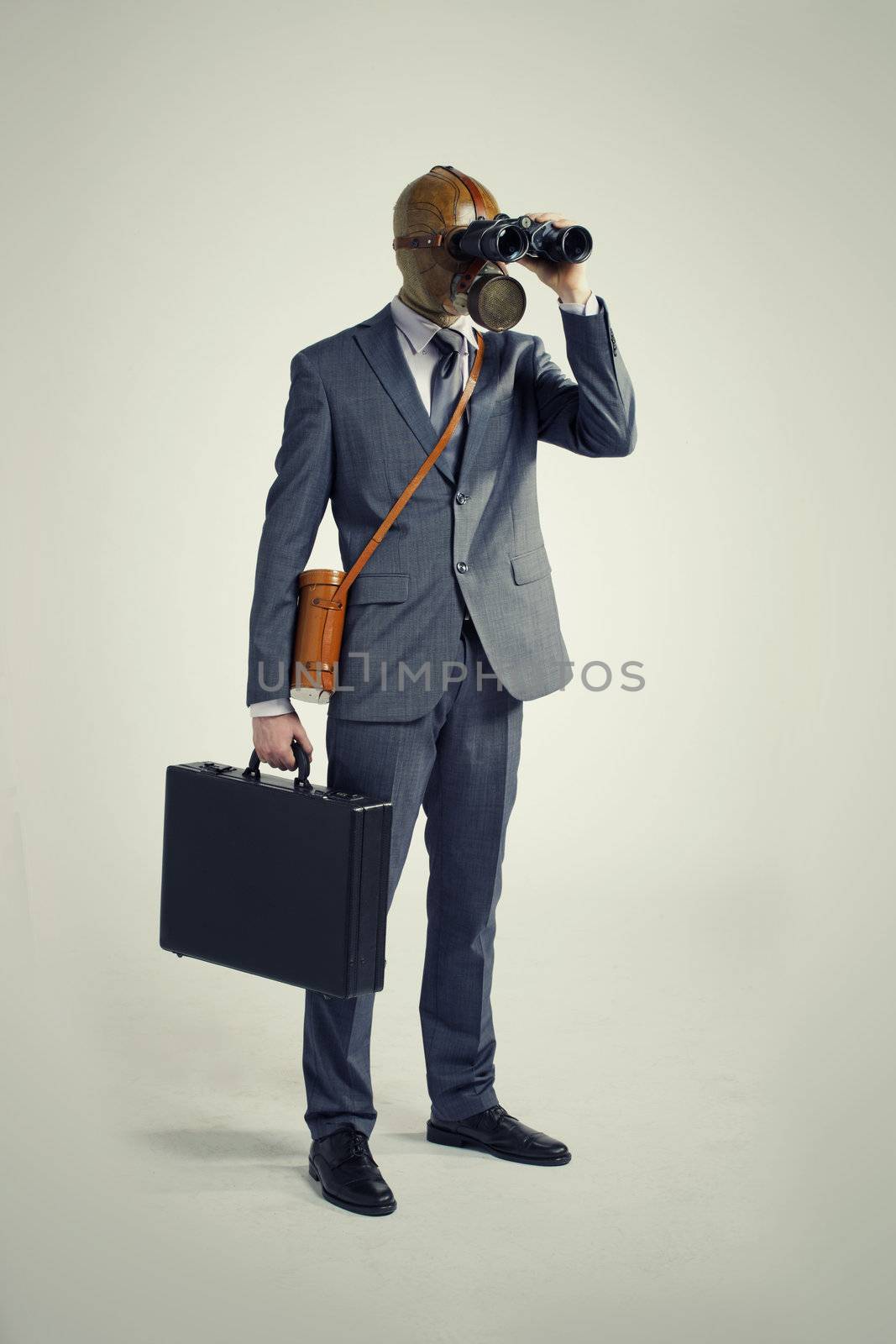 Businessman with gas mask  looking through binoculars