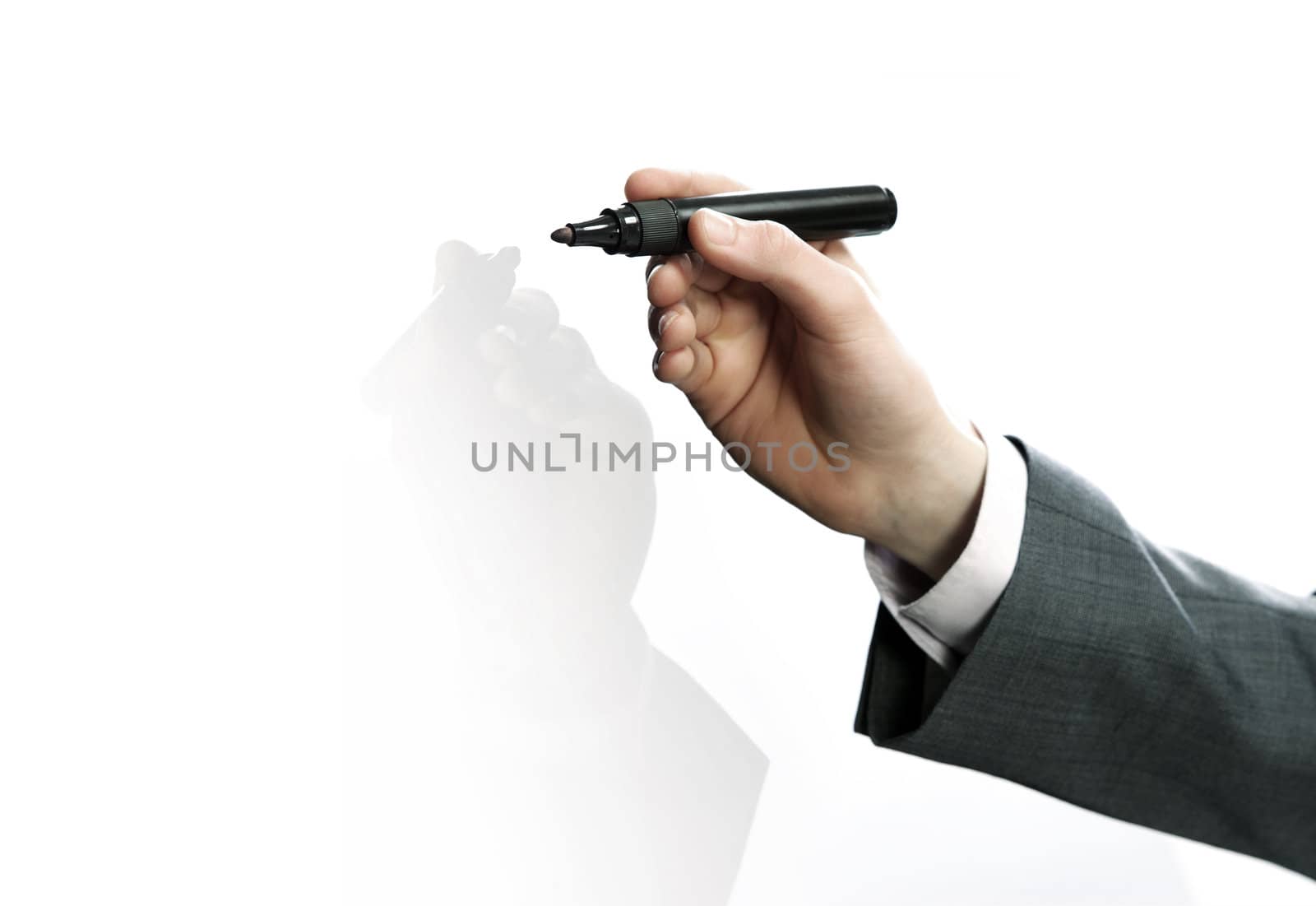 Businessman hand drawing in a whiteboard by stokkete