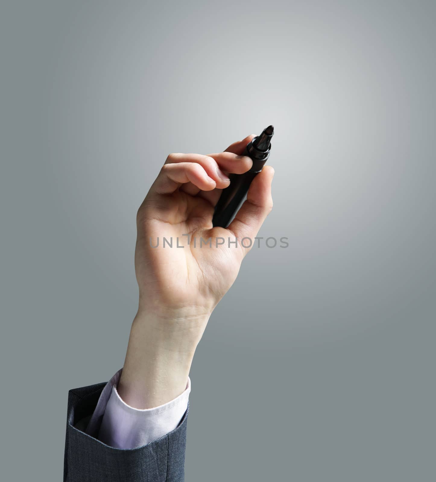 Businessman hand drawing in a whiteboard by stokkete