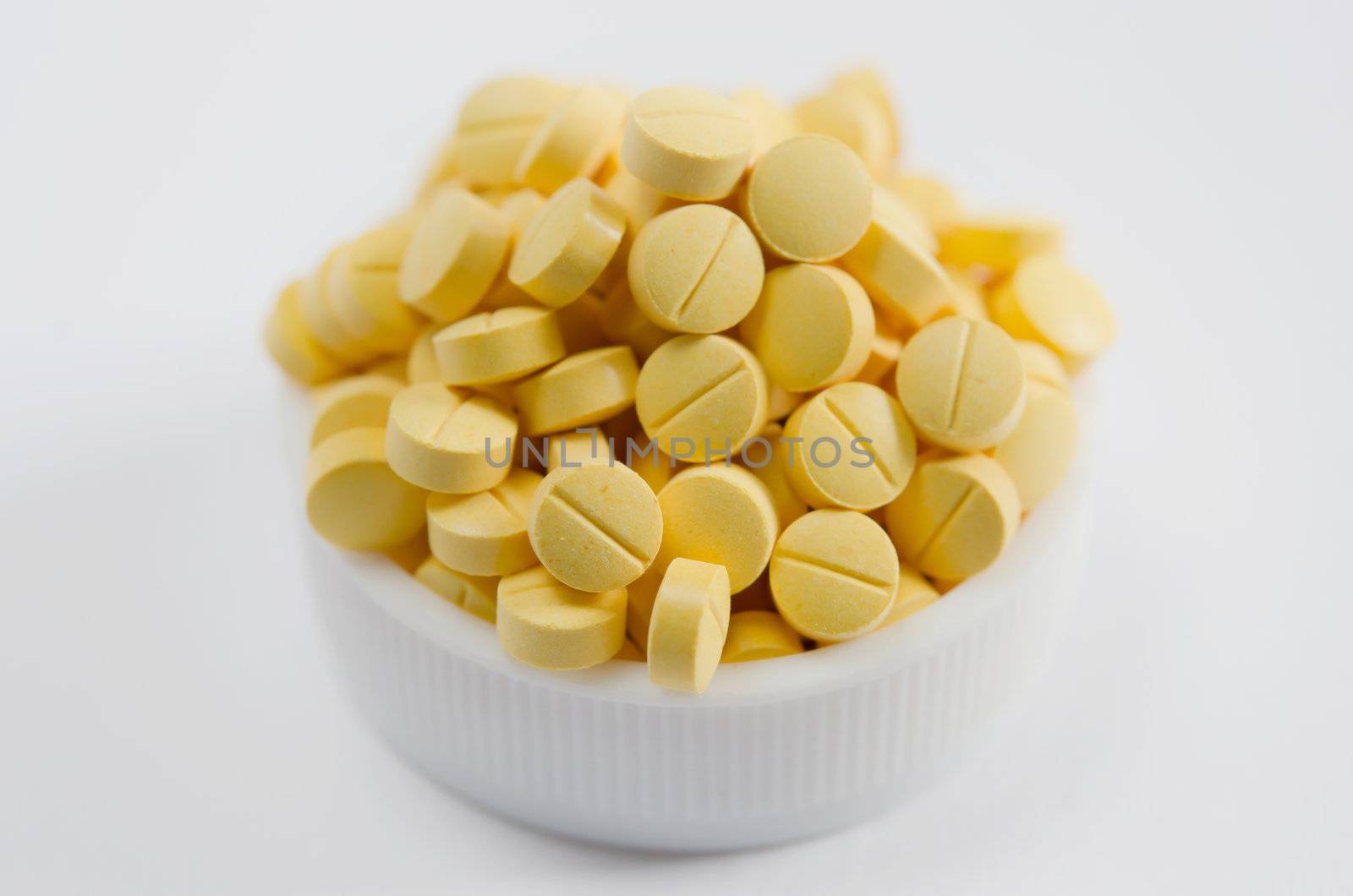 close-up of  yellow pills  on the white background