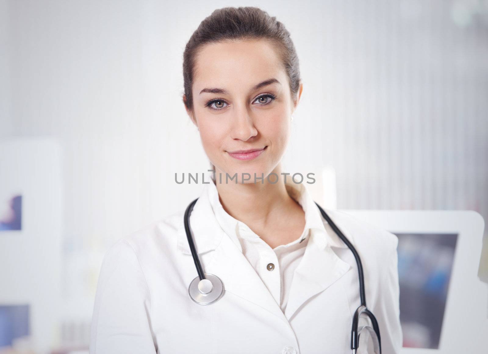 at pharmacy: portrait of  smiling young woman pharmacist with stethoscope