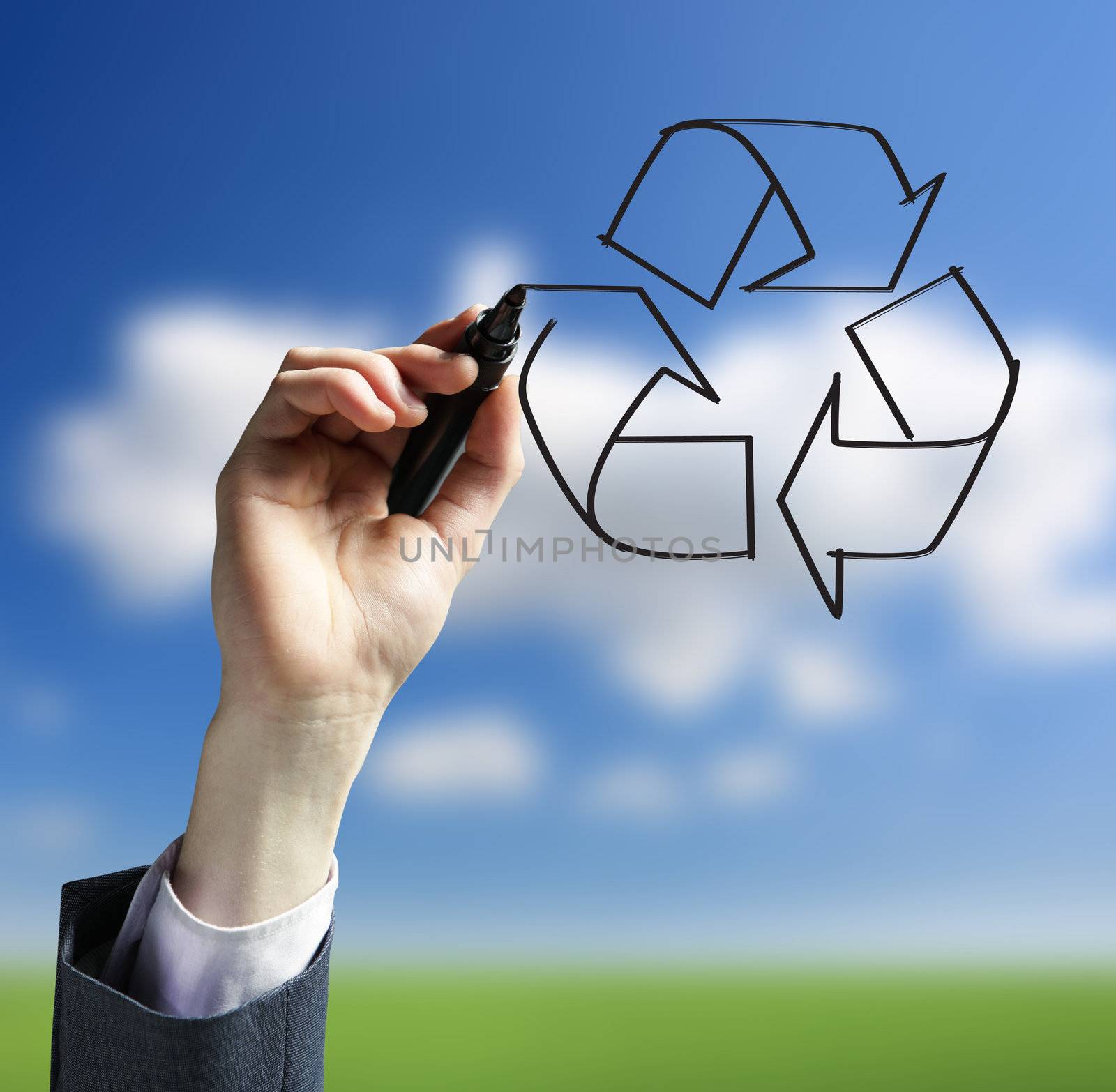 Businessman hand drawing a recycling logo