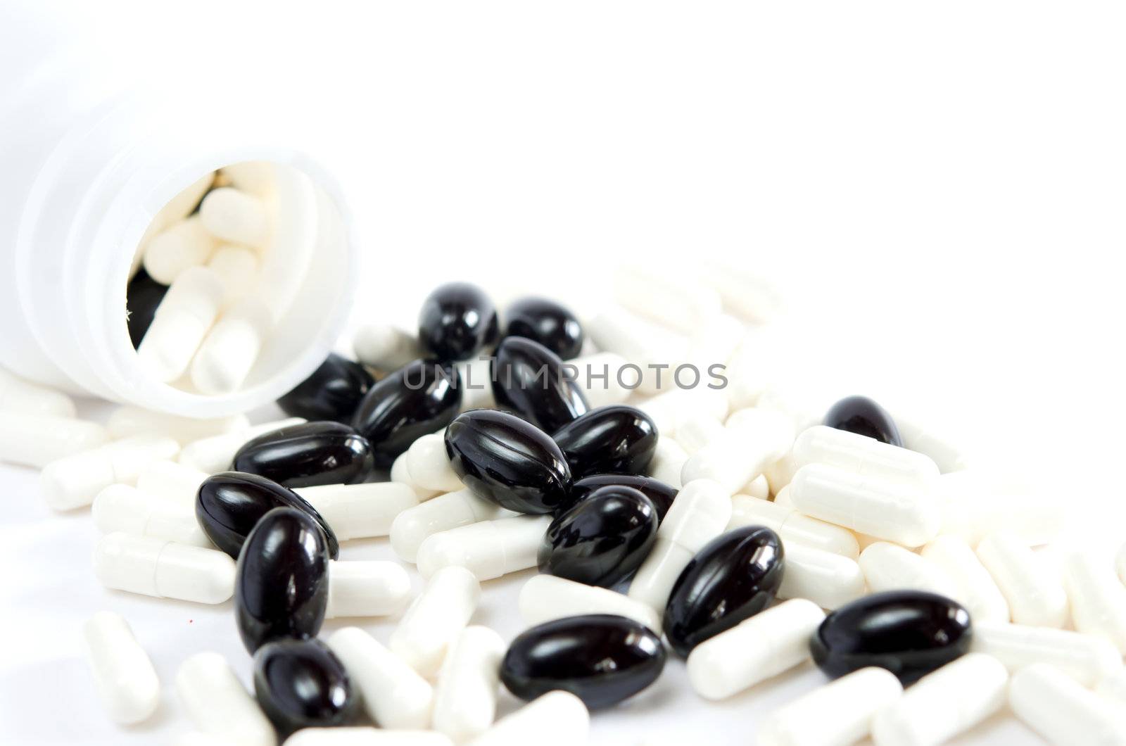 many pills spilling out of  pill bottle 
