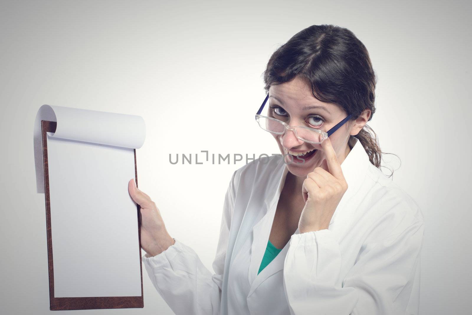 Female doctor holding blank clipboard. You can add your message to the clipboard.
