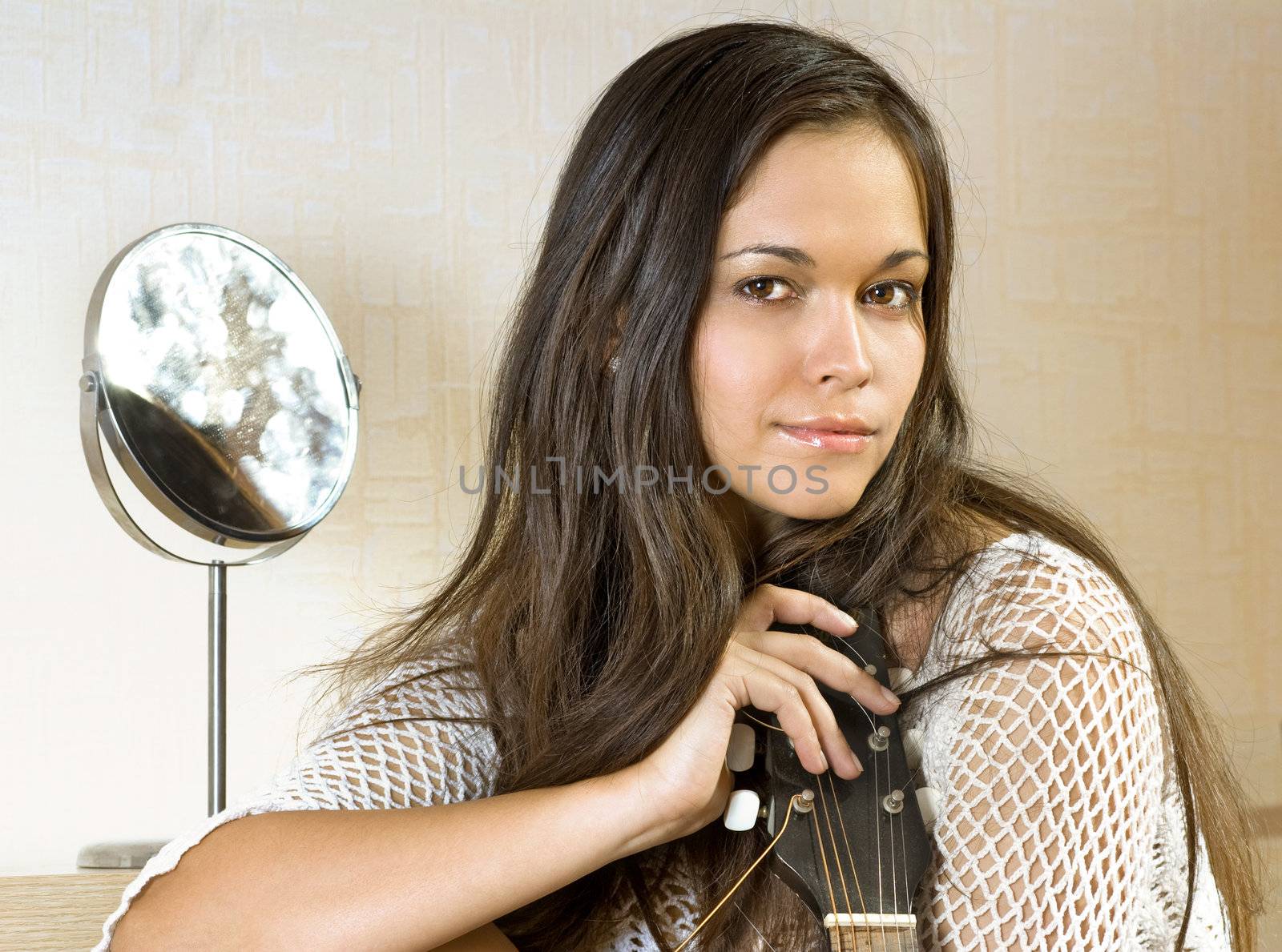 beautiful young lady in a room with guitar