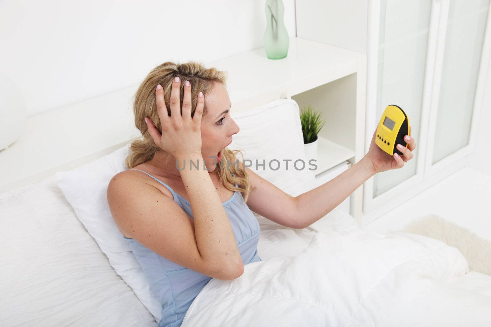 Woman looking at alarm clock in horror by Farina6000