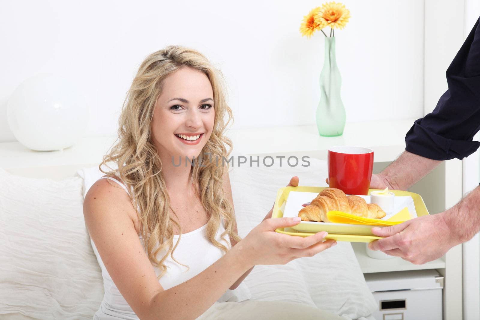 Young woman being treated to breakfast in bed by Farina6000