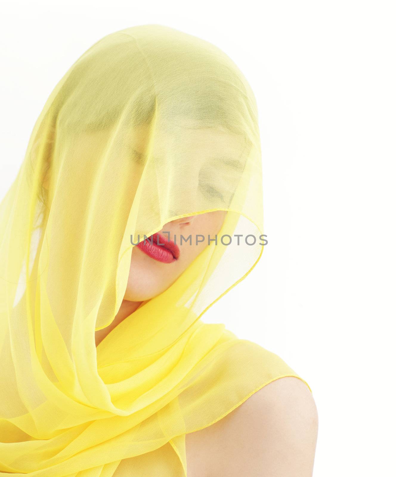 Young beautiful woman hidden by a veil 
