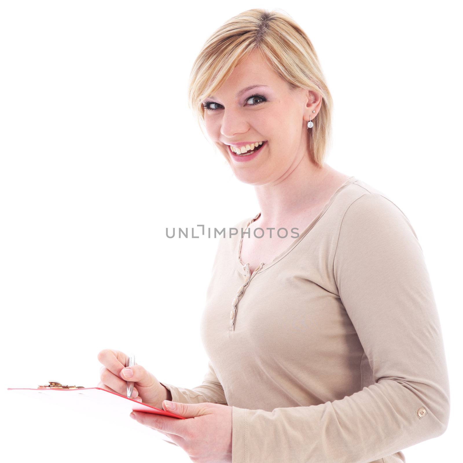 Vivacious young blonde secretary laughing in amusement while taking notes on a handheld folder