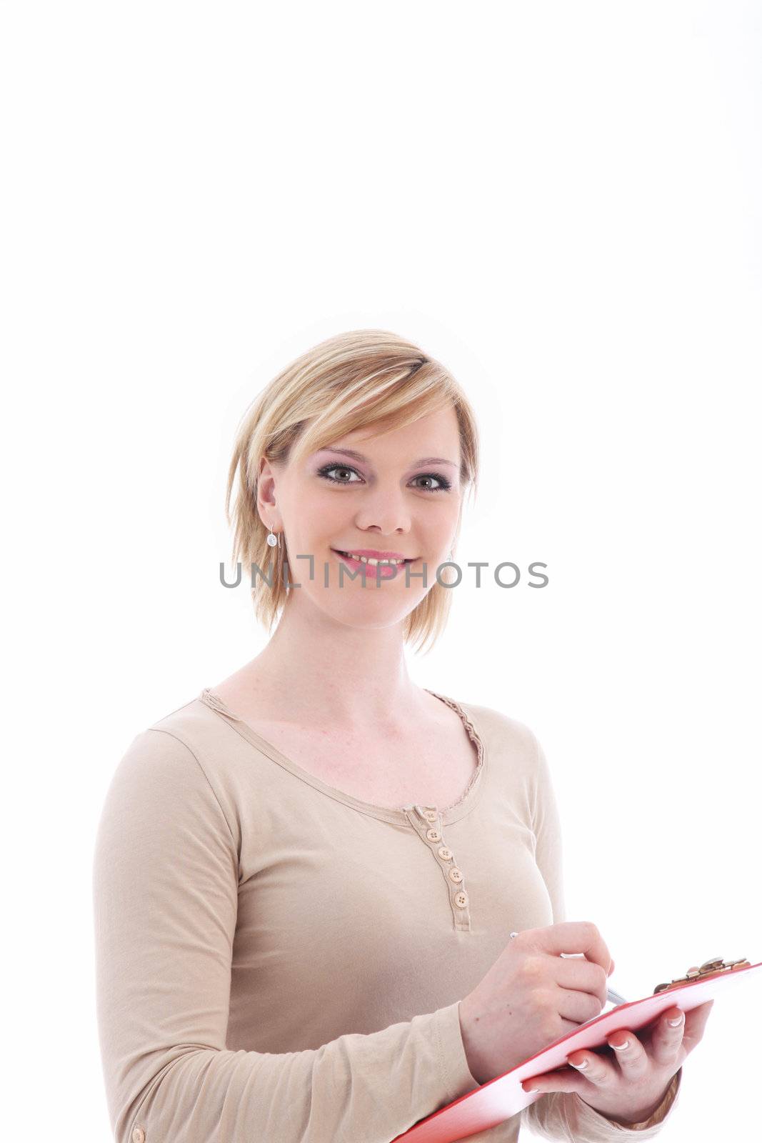 Friendly casual woman writing in a folder which she is holding in her hand isolated on white