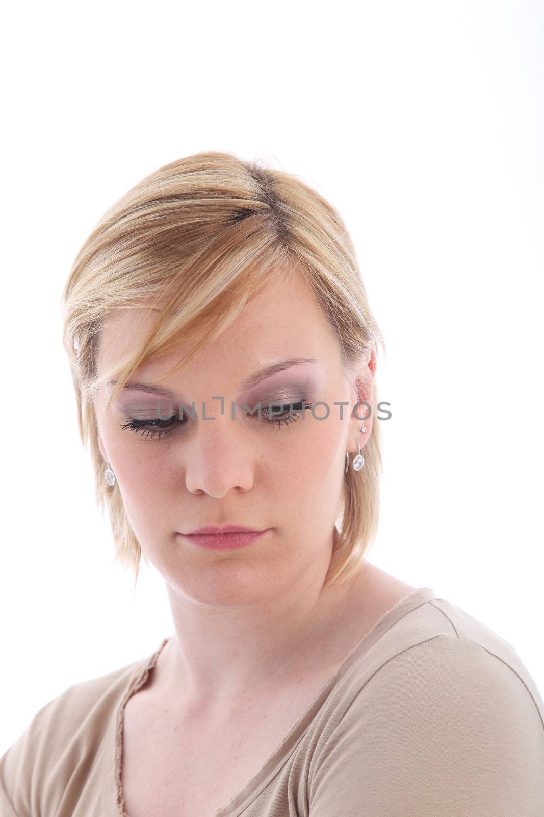 Portrait of sad blonde woman on white background