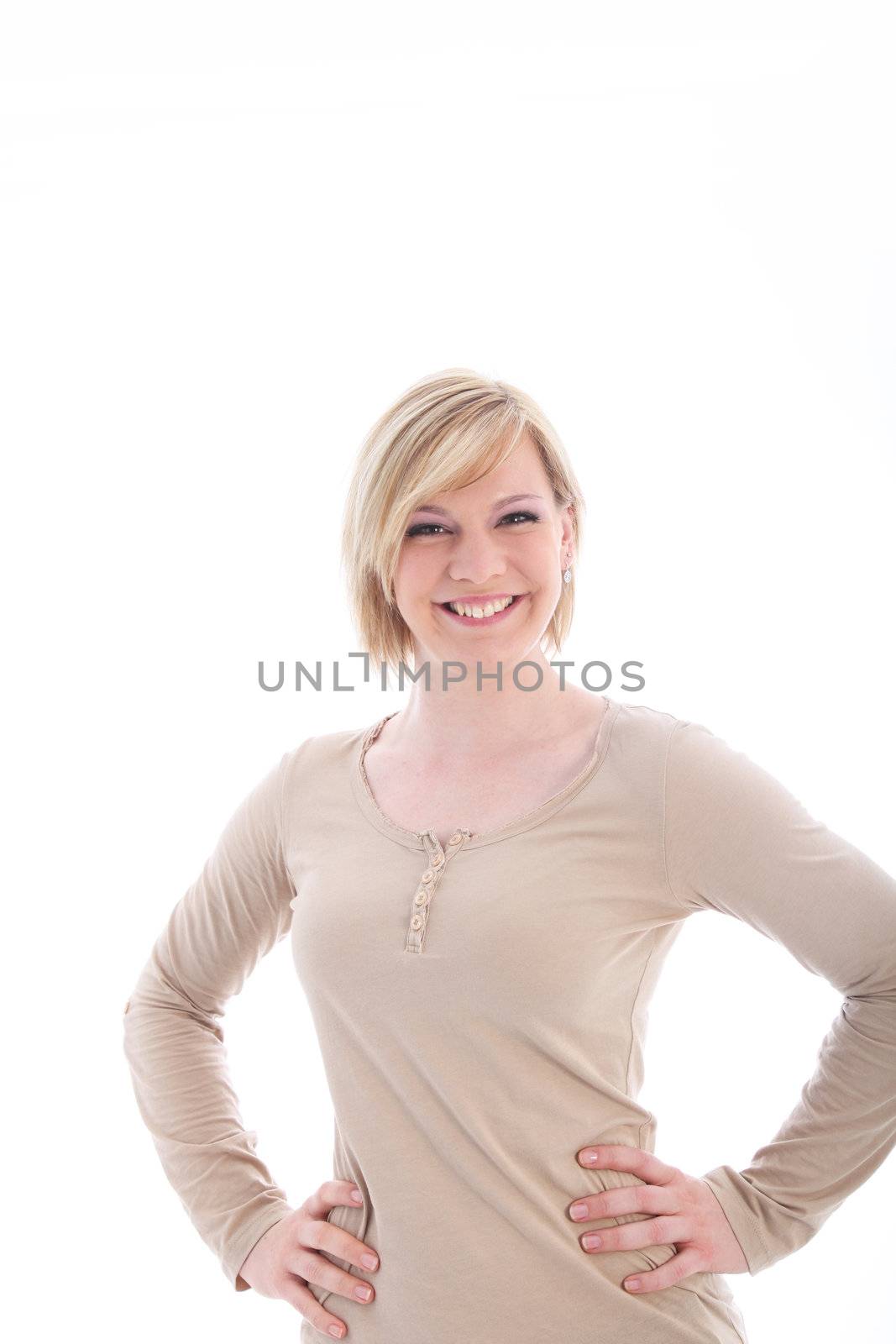 Smiling blonde woman with her hands on her hips isolated on white