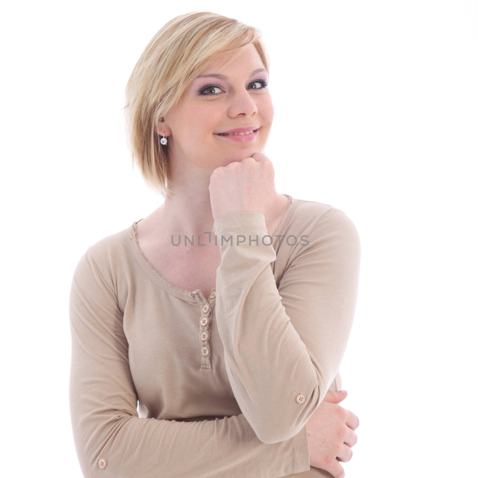 Attractive young woman smiling as she stands thinking with her chin resting on her hand isolated on white
