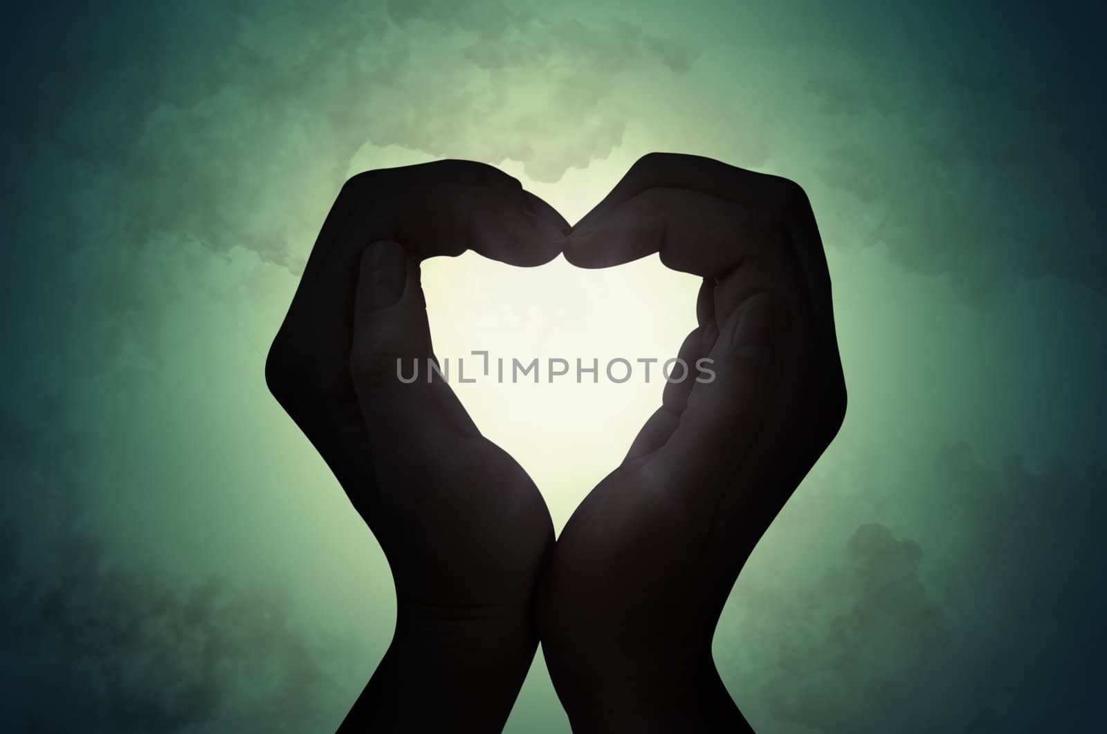 love shape hand silhouette in sky