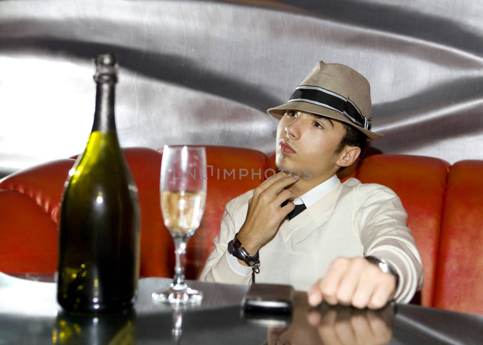 Attractive young gangster drinking in cocktail party at cabaret