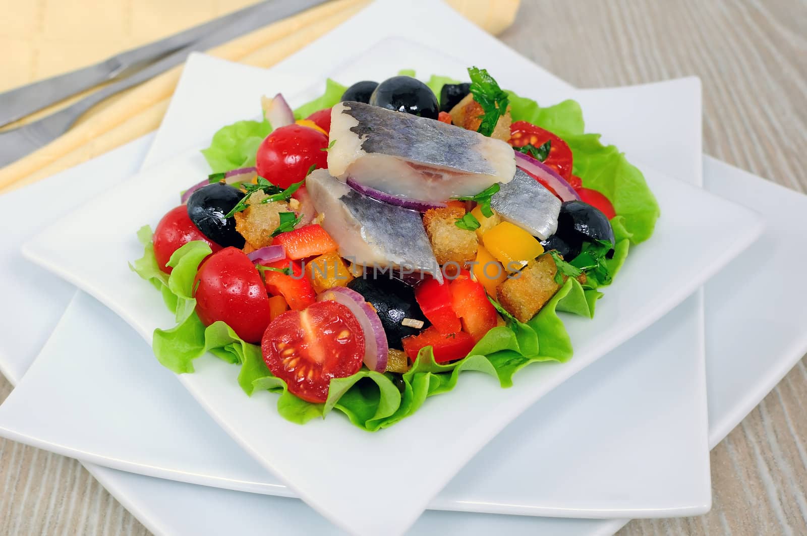 Appetizer of fresh vegetables with crackers and herring