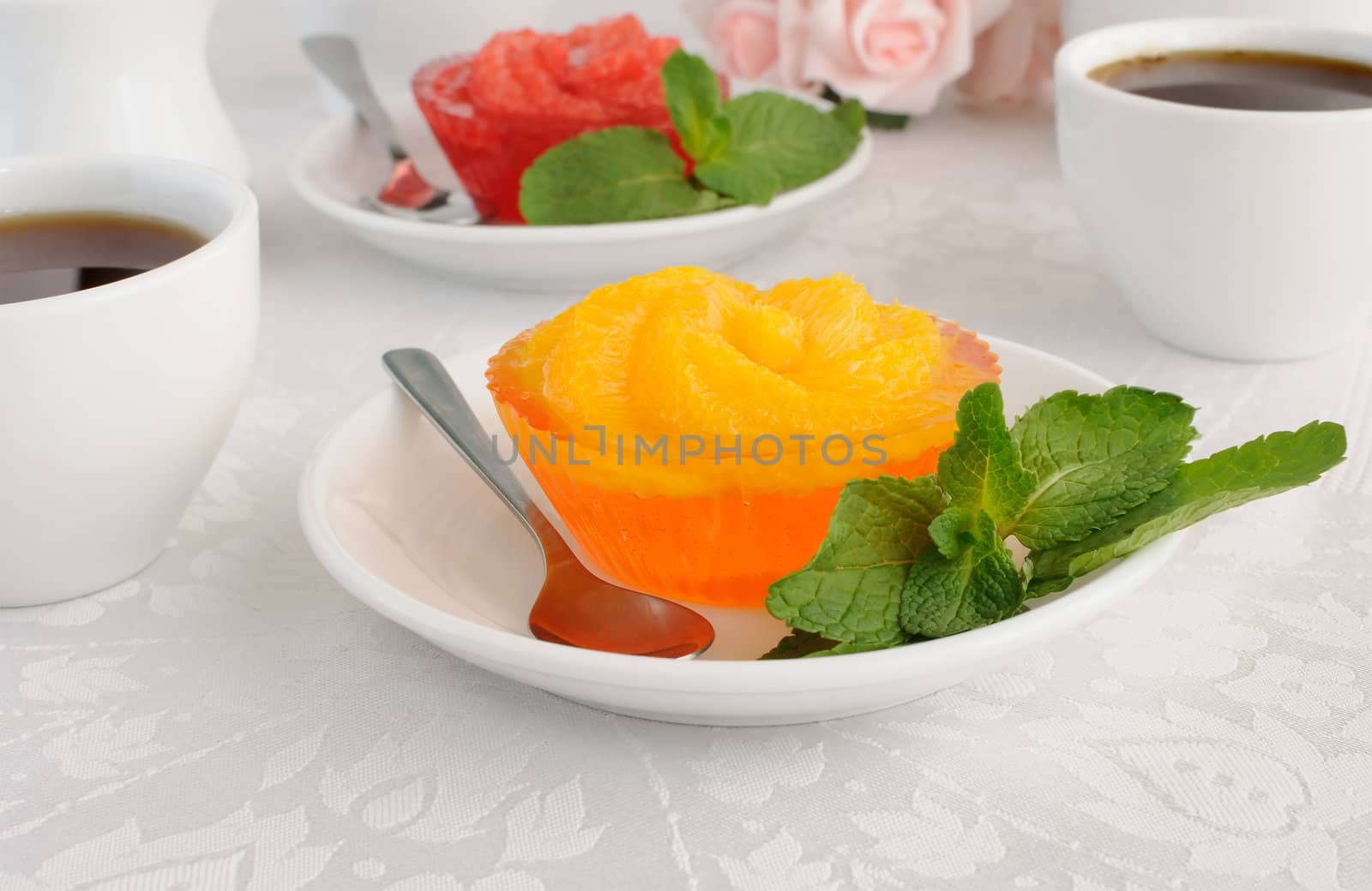 Dessert of orange jelly with fresh orange slices with a cup of coffee