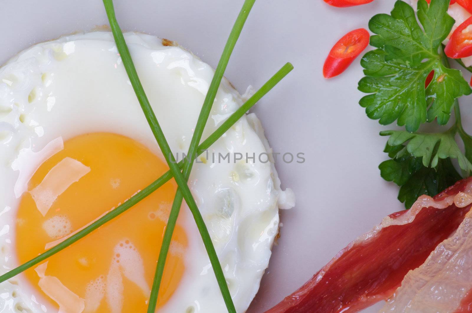 Fried Eggs Sunny Side Up with Bacon, Parsley and Lettuce by zhekos