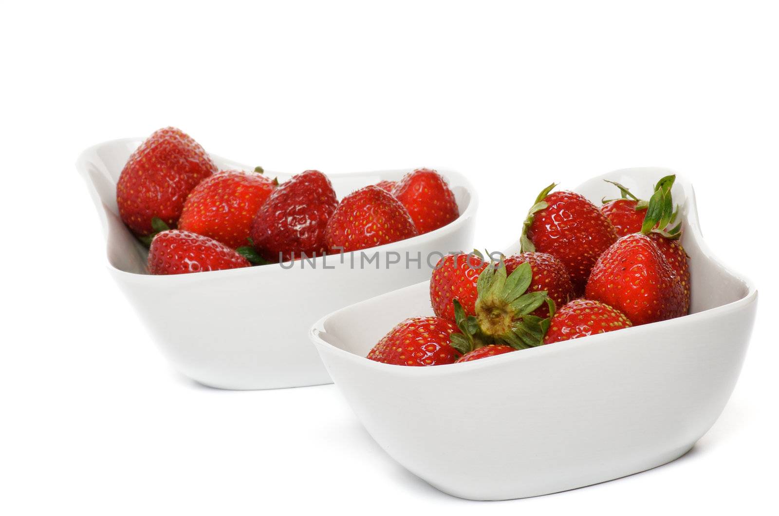 Fresh Ripe Perfect Strawberriy in two white bowl isolated on white background