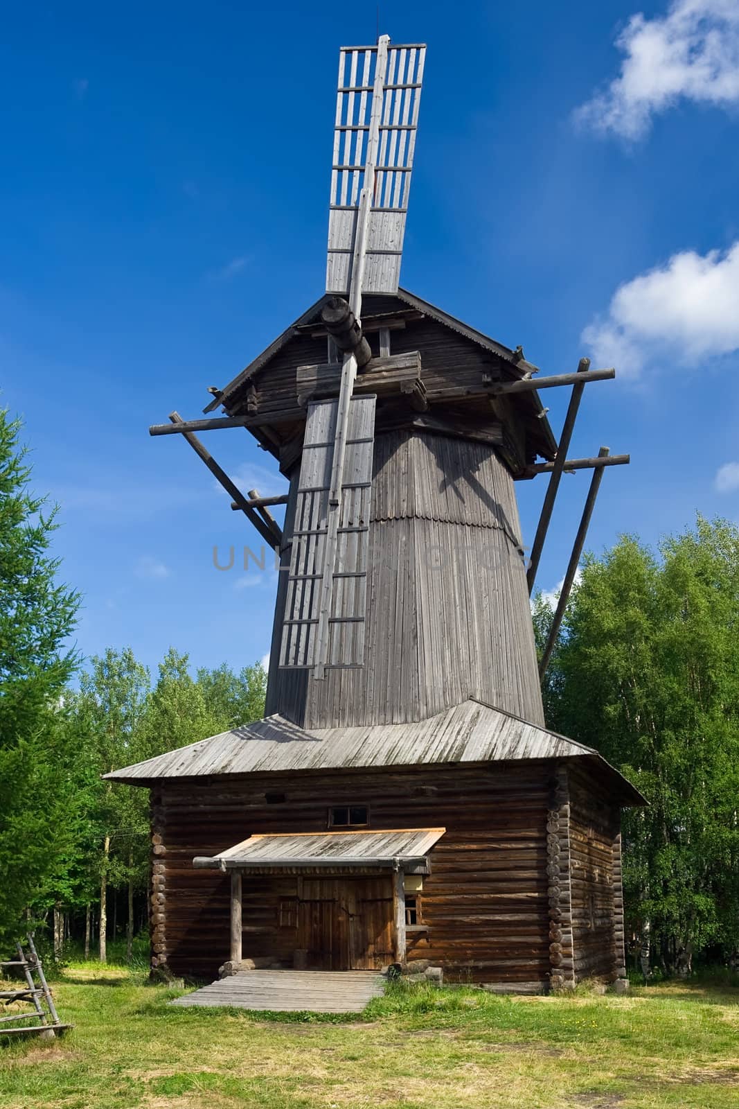 Old windmill under blue sky