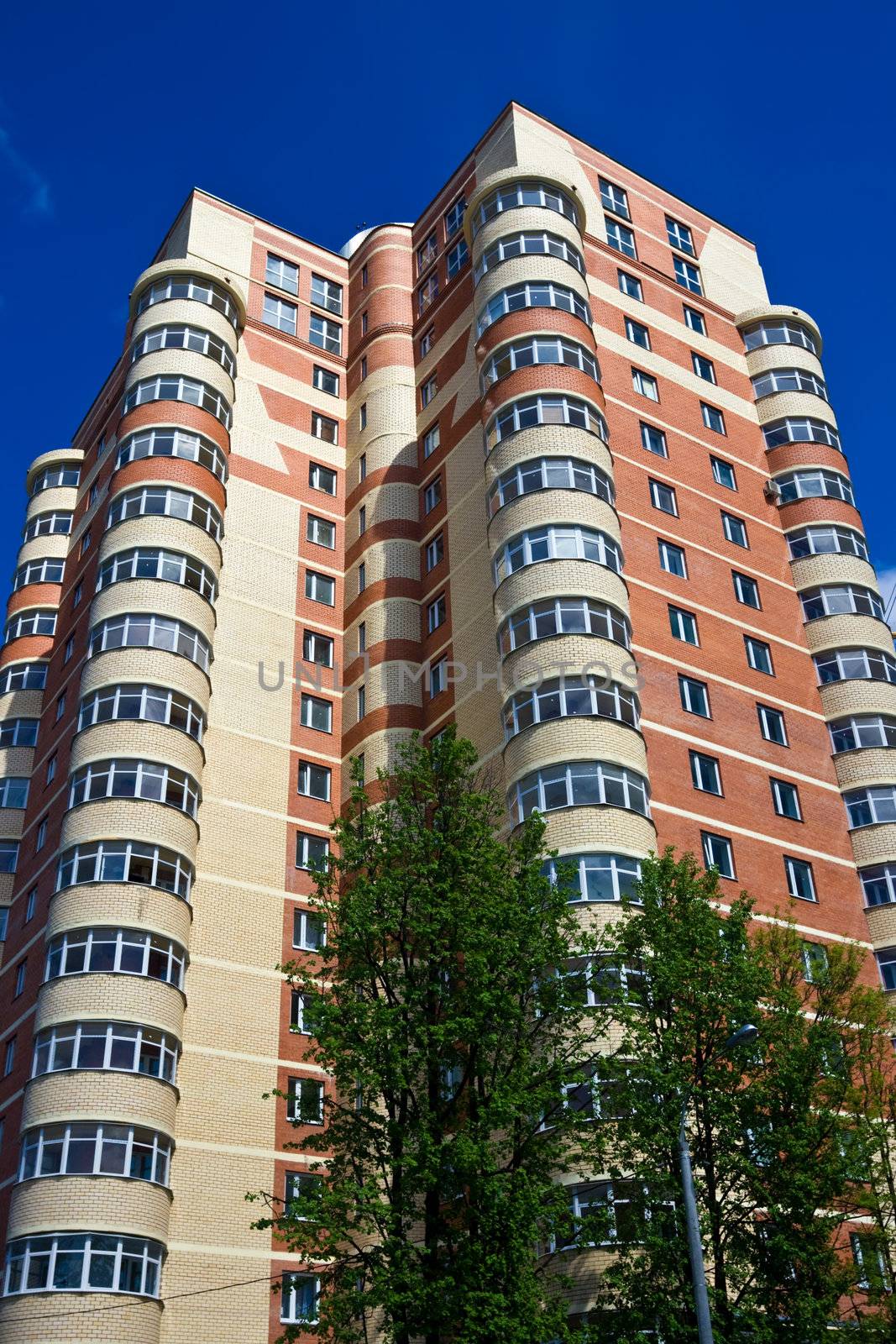 High modern apartment building under blue sky