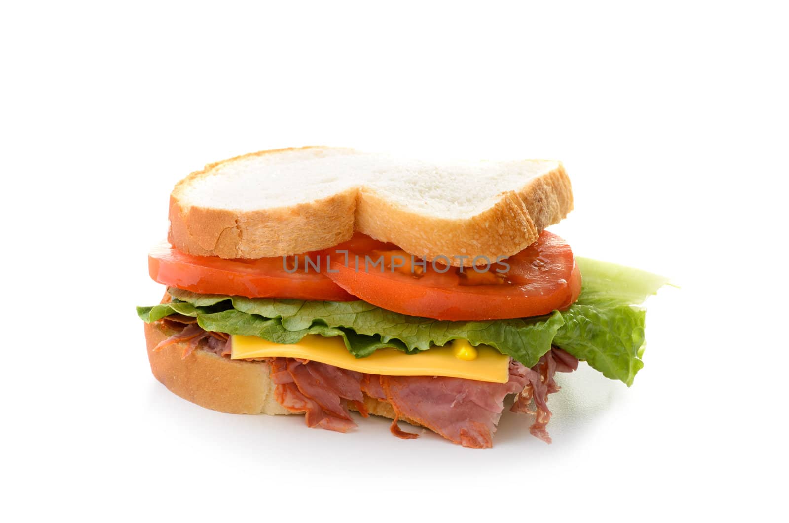 A corned beef sandwich with lettuce and tomatoes.