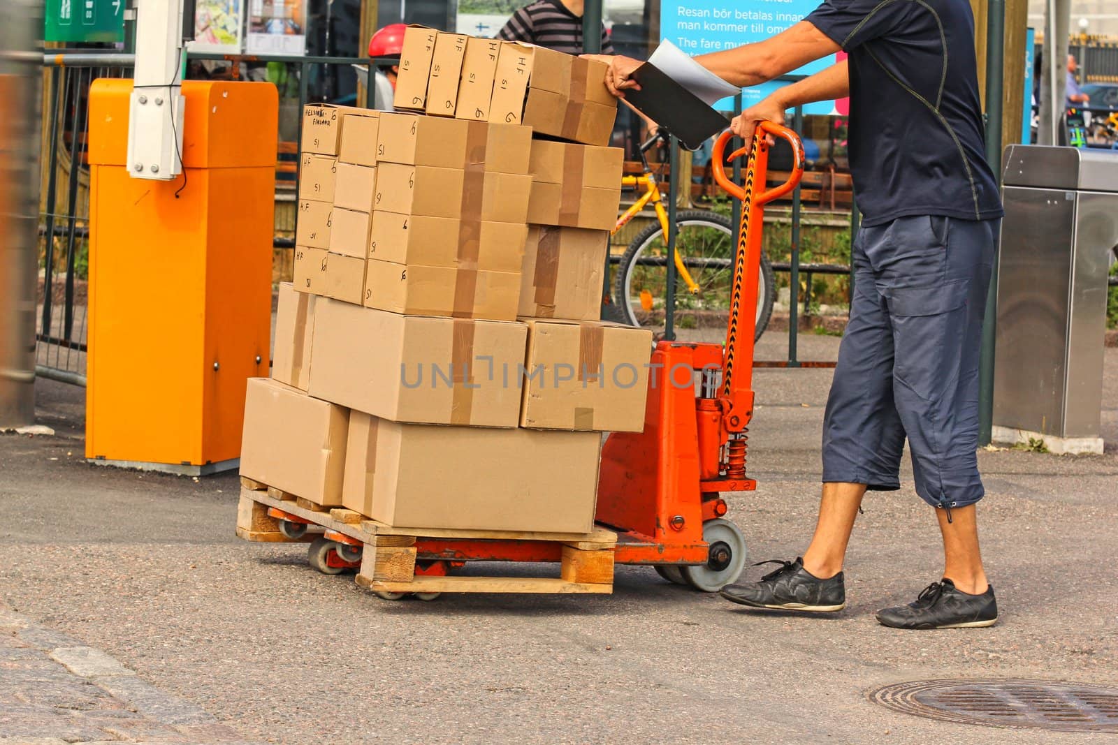 A fork pallet truck stacker with stack of boxes by Arvebettum