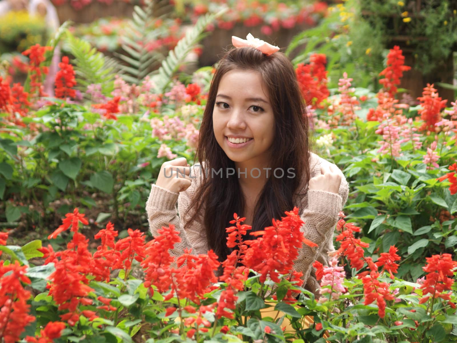 A smile of Asia beautiful girl  on a background of colorfull flower