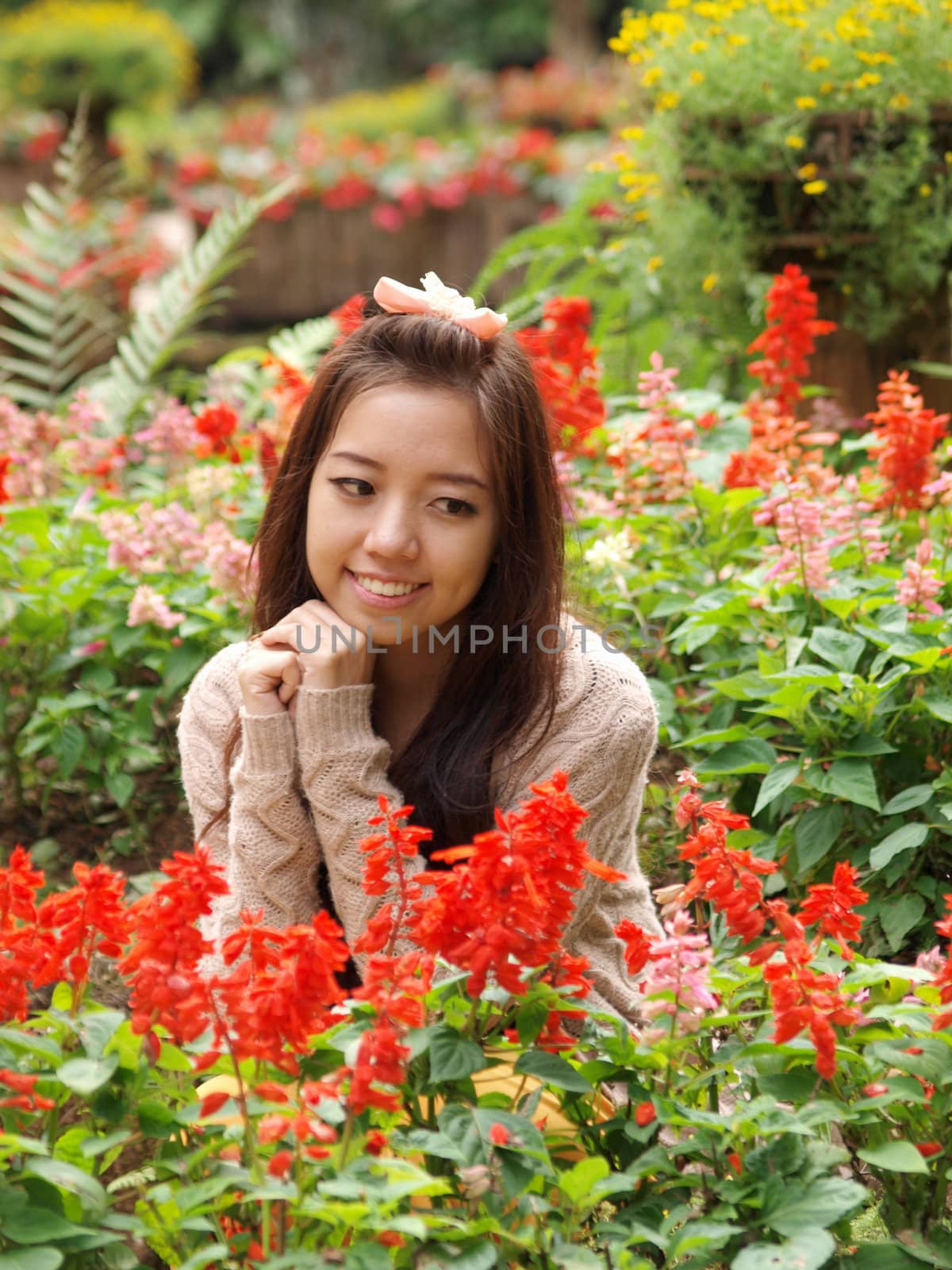A smile of Asia beautiful girl  on a colorfull flower background by jakgree
