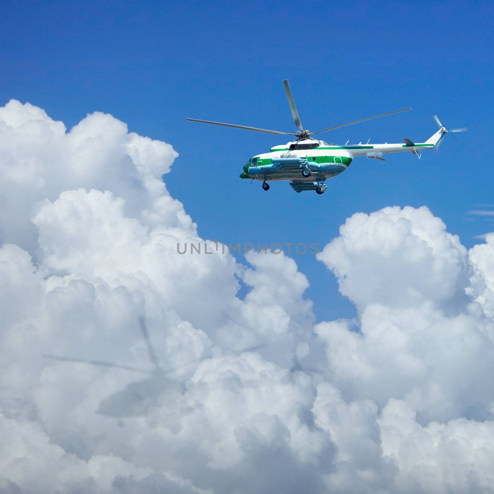 The helicopter is flying above the clouds