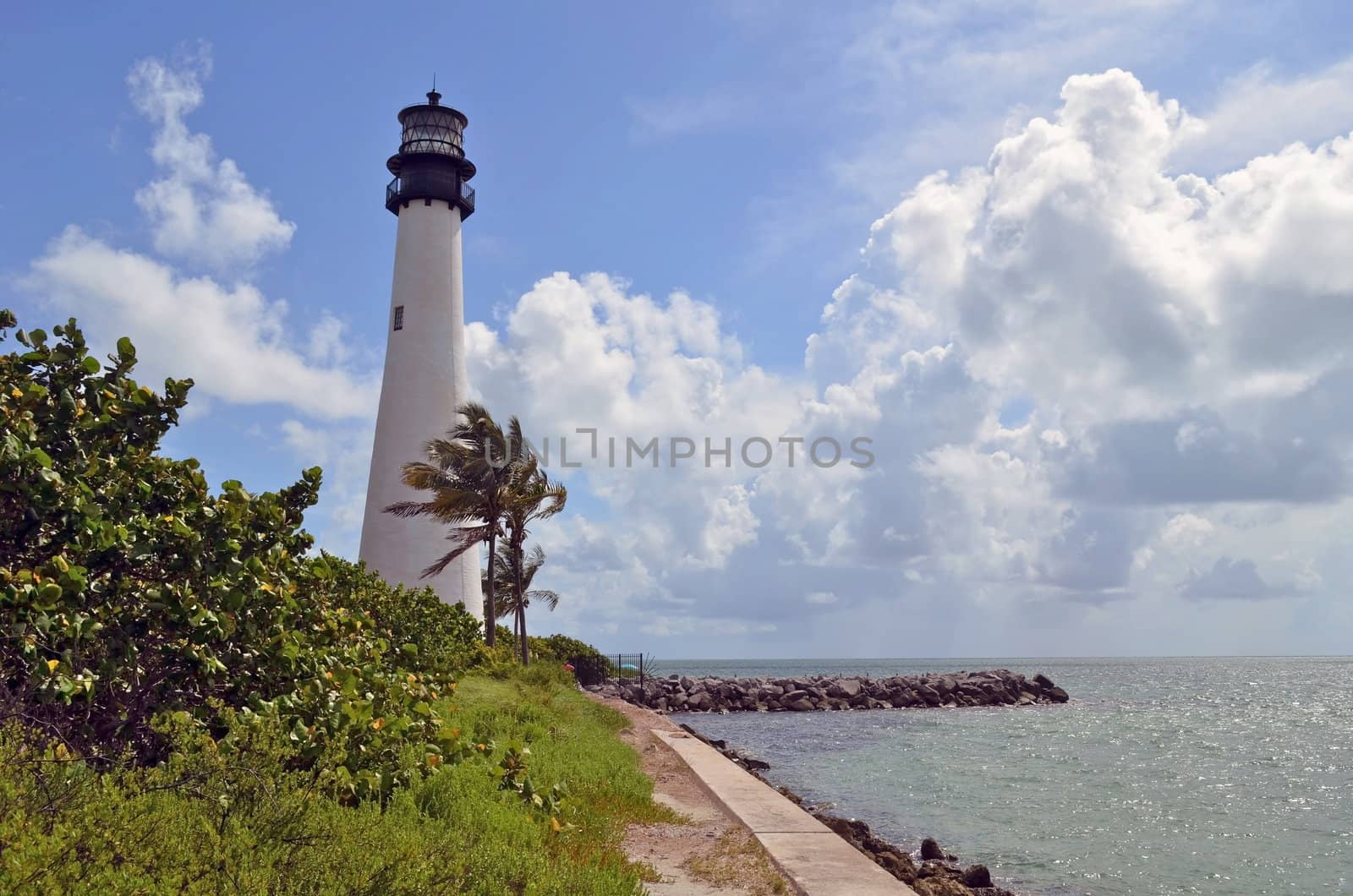 Lighthouse overlooking the beach at Bill Baggs State Park on Key Biscayne,Florida a popular attraction for tourists and local residents.