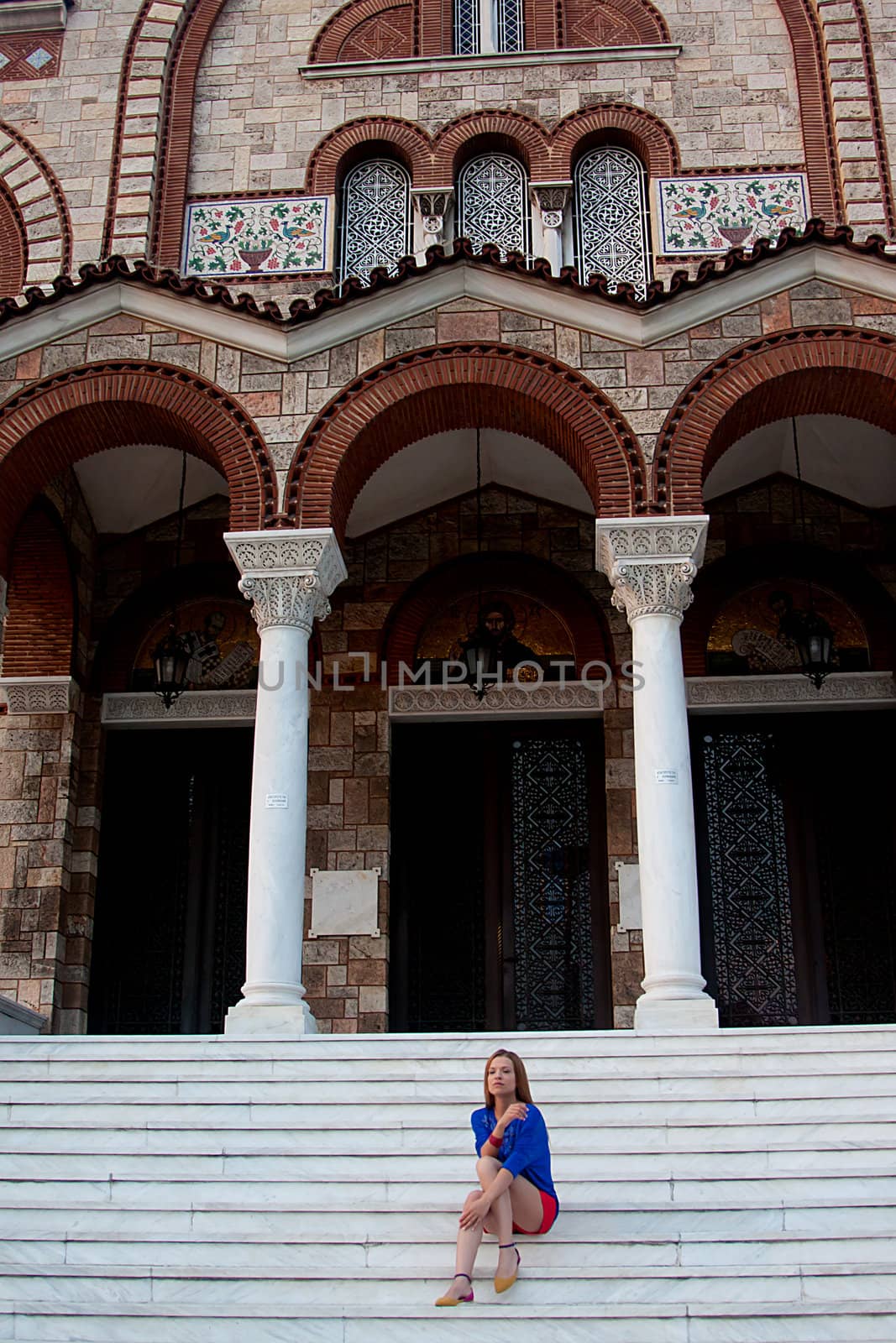 young and beautiful woman sitting on the steps of