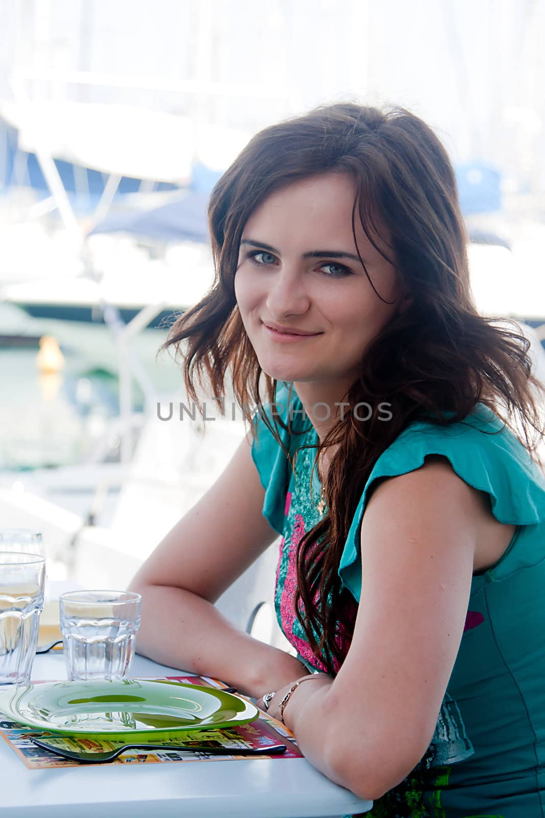 Young and beautiful girl sitting at a coffee shop waiting for my order