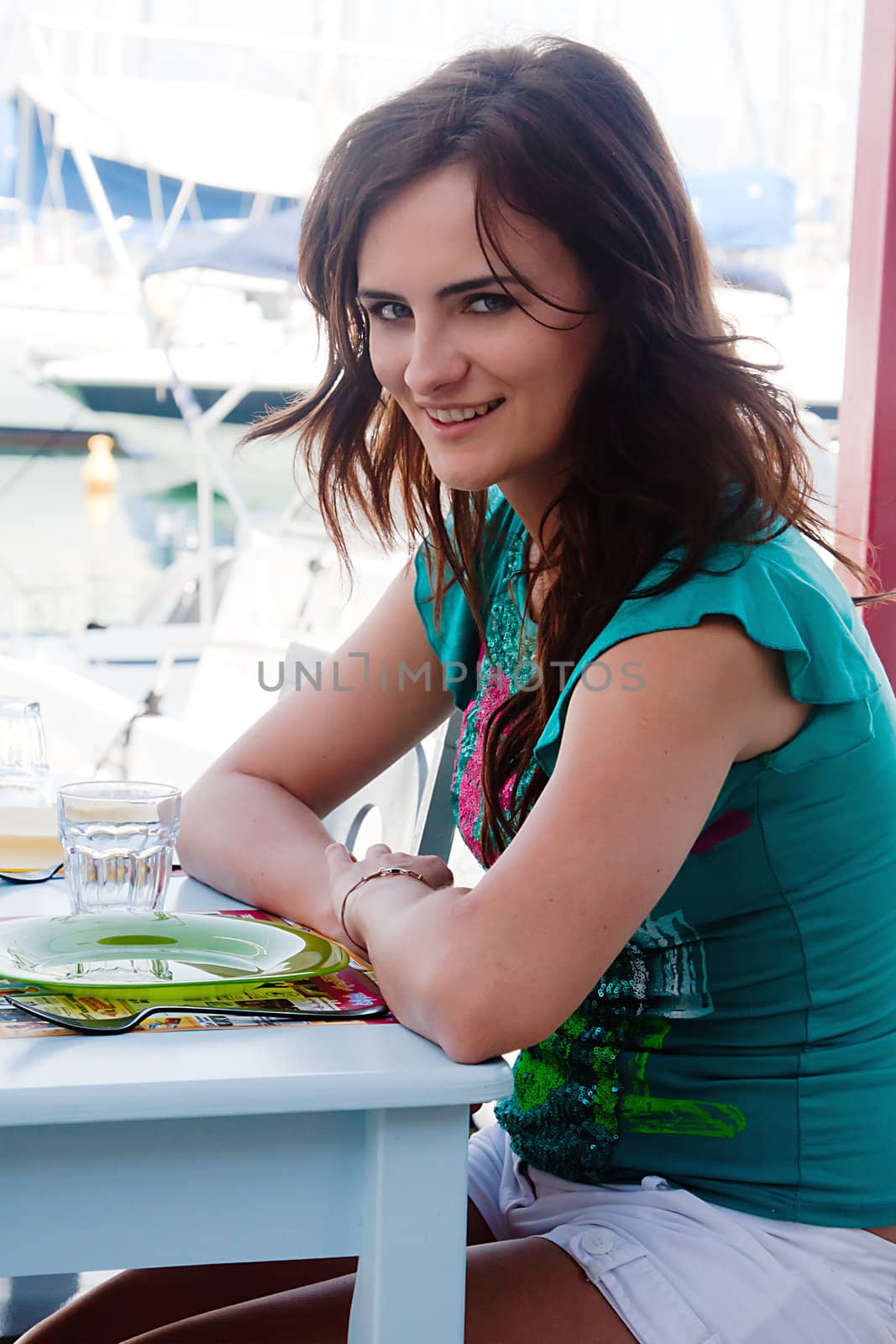 Young and beautiful girl sitting at a coffee shop waiting for my order