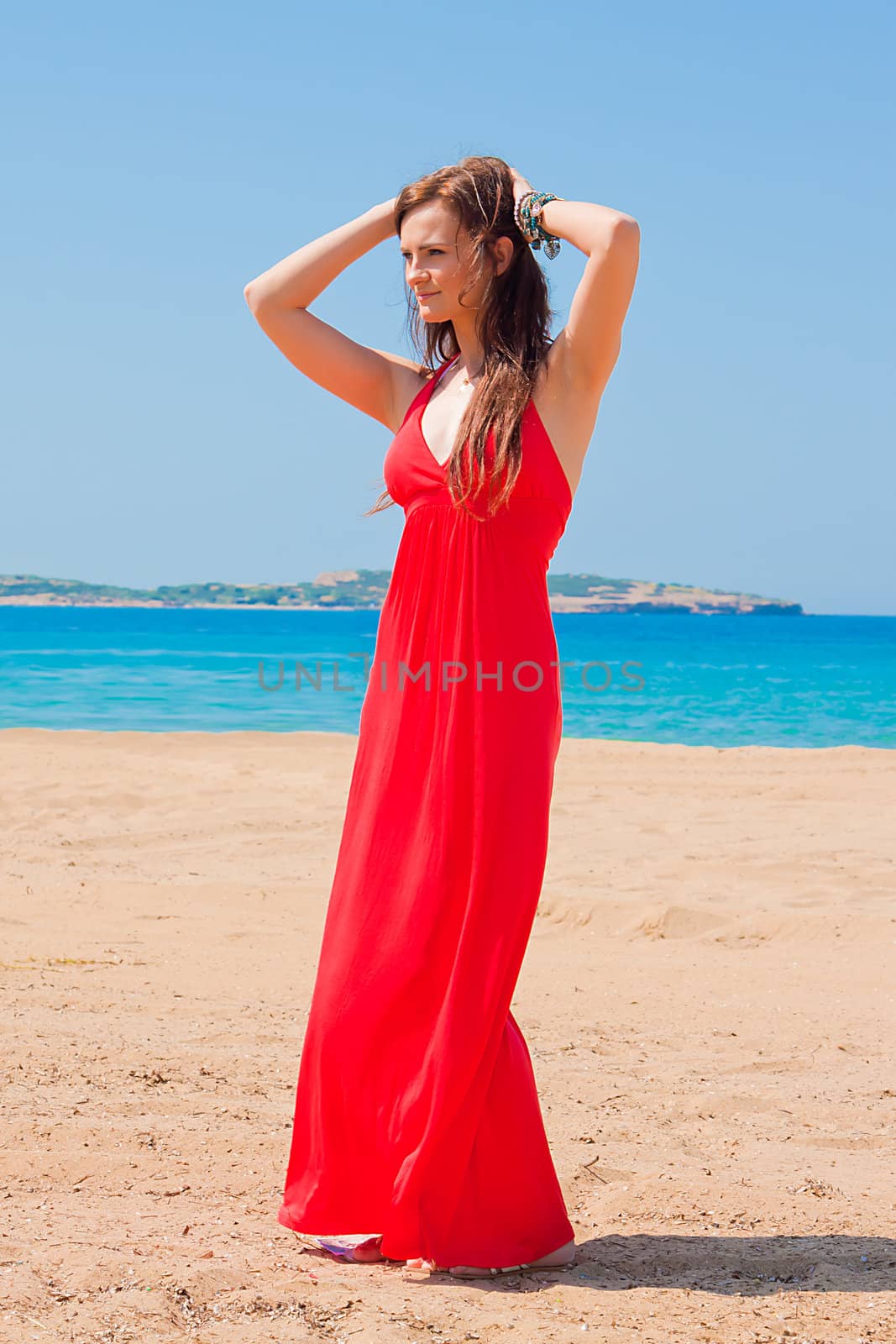 Photo of a young and beautiful woman resting on the sea coast